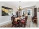 Bright dining area featuring a wooden table and chairs with a neutral color palette at 2606 Pinyonpine Ln, Sanford, FL 32773