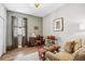 Home office with hardwood floors and walls painted in neutral colors, a desk, and a comfortable sofa at 2606 Pinyonpine Ln, Sanford, FL 32773