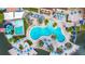 Resort-style pool with slide, sun umbrellas, palm trees, and lake access for luxury vacation living at 2708 Bushman Dr, Kissimmee, FL 34746