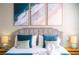 Comfortable bedroom with beach-themed artwork, a plush bed, and soft lighting at 2708 Bushman Dr, Kissimmee, FL 34746