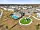 Aerial view of a community pool, playground, and surrounding homes at 2788 Pleasant Cypress Cir, Kissimmee, FL 34741