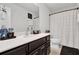 Bathroom with dual-sink vanity, modern fixtures, framed mirror, and toilet at 2788 Pleasant Cypress Cir, Kissimmee, FL 34741