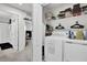 Laundry room with washer, dryer, and built-in shelving, adjacent to a bedroom at 2788 Pleasant Cypress Cir, Kissimmee, FL 34741