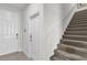 Carpeted staircase with white railing and multiple doors nearby at 2788 Pleasant Cypress Cir, Kissimmee, FL 34741