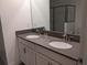 Modern bathroom featuring dual sinks, sleek countertops, and a glass-enclosed shower at 2800 Simile St, Kissimmee, FL 34746