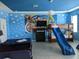 Fun bedroom featuring themed decor, bunk beds with slide, and plenty of play space at 2800 Simile St, Kissimmee, FL 34746