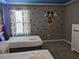 Themed bedroom featuring two beds, playful accents, and a Mickey Mouse motif at 2800 Simile St, Kissimmee, FL 34746