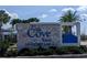 Stone sign for The Cove East at Storey Lake with manicured landscaping and blue accents at 2800 Simile St, Kissimmee, FL 34746