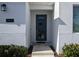 Close-up of the modern front door with sidelight windows, and a textured stucco exterior at 2800 Simile St, Kissimmee, FL 34746