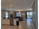 Open-concept living room with a view of the kitchen, pool, and sliding glass doors at 2800 Simile St, Kissimmee, FL 34746