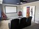 Spacious theater room with projector, screen, and comfortable seating for an immersive entertainment experience at 2800 Simile St, Kissimmee, FL 34746