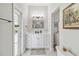 Modern bathroom featuring a white vanity, tiled floors, and an exterior door to the pool area at 2929 University Acres Dr, Orlando, FL 32817