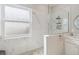 Bright bathroom featuring a large, glass enclosed shower with marble tiling and a decorative stone floor at 2929 University Acres Dr, Orlando, FL 32817