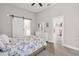 Bedroom showcasing a barn door leading to an ensuite bathroom with a dresser and decorative mirror at 2929 University Acres Dr, Orlando, FL 32817