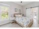 Cozy bedroom with a barn door, light walls, and a view of the outdoors at 2929 University Acres Dr, Orlando, FL 32817