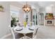 Bright breakfast nook with a modern light fixture, white table and chairs, and a view of the outdoors at 2929 University Acres Dr, Orlando, FL 32817