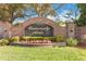 Welcoming entrance to University Acres with a beautiful brick sign and manicured landscaping at 2929 University Acres Dr, Orlando, FL 32817