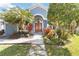 Inviting front entrance with a beautiful double door and lush, colorful landscaping for a warm welcome at 2929 University Acres Dr, Orlando, FL 32817