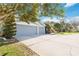 Exterior view of the home's 3-car garage with a spacious driveway and well-maintained landscaping at 2929 University Acres Dr, Orlando, FL 32817