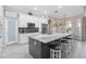 Modern kitchen featuring an oversized island with bar seating, stainless appliances, and white cabinets at 2929 University Acres Dr, Orlando, FL 32817