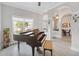 Bright living room featuring a piano, neutral walls, and view into dining area at 2929 University Acres Dr, Orlando, FL 32817