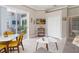 Open concept living room with bright yellow chairs and a view of the pool deck at 2929 University Acres Dr, Orlando, FL 32817