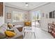 Living room with ample natural light, view of the pool deck, and modern furniture at 2929 University Acres Dr, Orlando, FL 32817