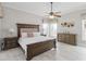 Spacious main bedroom with a ceiling fan, decorative headboard, and neutral color palette at 2929 University Acres Dr, Orlando, FL 32817