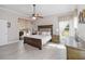 This main bedroom features a ceiling fan, a large bed, and sliding glass doors to the pool deck at 2929 University Acres Dr, Orlando, FL 32817