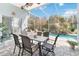 Outdoor patio with a dining area, a screened enclosure, and a view of the pool at 2929 University Acres Dr, Orlando, FL 32817