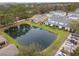 Aerial view of homes with a serene pond and lush greenery, creating a peaceful neighborhood setting at 2956 Oak Park Way # 45, Orlando, FL 32822