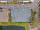 Aerial view of well-maintained townhome roofs near a small pond with parking and street access at 2956 Oak Park Way # 45, Orlando, FL 32822