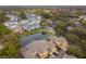 Scenic aerial view of townhomes with a calming pond and mature trees, showcasing a desirable community at 2956 Oak Park Way # 45, Orlando, FL 32822