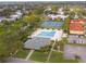 Aerial view of community pool, tennis courts, ample parking, landscaping, and surrounding neighborhood at 2956 Oak Park Way # 45, Orlando, FL 32822