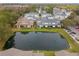 A picturesque aerial view of homes surrounding a tranquil pond, offering a serene residential atmosphere at 2956 Oak Park Way # 45, Orlando, FL 32822