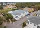 Aerial view of modern townhomes, with pond, mature trees, and residential street at 2956 Oak Park Way # 45, Orlando, FL 32822