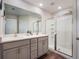 Bright bathroom featuring double sinks, gray cabinetry and large glass enclosed shower at 2956 Oak Park Way # 45, Orlando, FL 32822