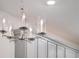 Close-up shot of an elegant chandelier hanging above the kitchen island, surrounded by contemporary cabinetry at 2956 Oak Park Way # 45, Orlando, FL 32822