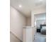 Upstairs hallway with carpet flooring, closet and open doorway that shows the main bedroom with a queen bed at 2956 Oak Park Way # 45, Orlando, FL 32822