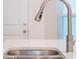 Close up of kitchen faucet and sink featuring quartz countertops at 2956 Oak Park Way # 45, Orlando, FL 32822