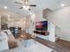 View of the living room with hardwood floors, view to the kitchen, dining area, and stairs leading to the second floor at 2956 Oak Park Way # 45, Orlando, FL 32822