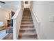 Carpeted staircase with white railings leads to the upper level, adjacent to a tastefully decorated living area at 2956 Oak Park Way # 45, Orlando, FL 32822