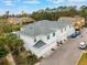 Rear view of townhomes featuring white siding, grey roof, blue shutters and well-maintained landscaping at 2956 Oak Park Way # 45, Orlando, FL 32822