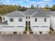 Beautiful townhome exterior featuring white siding, grey roof, turquoise shutters and a large driveway at 2956 Oak Park Way # 45, Orlando, FL 32822