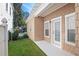 Backyard exterior showcasing a concrete walkway and well-maintained lawn at 2976 Saint George St, Orlando, FL 32814