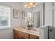 Bright bathroom showcasing a double vanity with marble countertop and a large mirror at 2976 Saint George St, Orlando, FL 32814