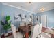 Cozy dining area with a wooden table set and modern artwork on the wall at 2976 Saint George St, Orlando, FL 32814