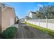 Community street view displaying garages and fencing on a sunny day at 2976 Saint George St, Orlando, FL 32814