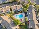 An aerial view of the townhome complex highlights a kidney-shaped pool surrounded by lush landscaping at 311 Sandlewood Trl # 4, Winter Park, FL 32789