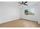 Bright bedroom features a modern ceiling fan and a large window with an outside view at 311 Sandlewood Trl # 4, Winter Park, FL 32789